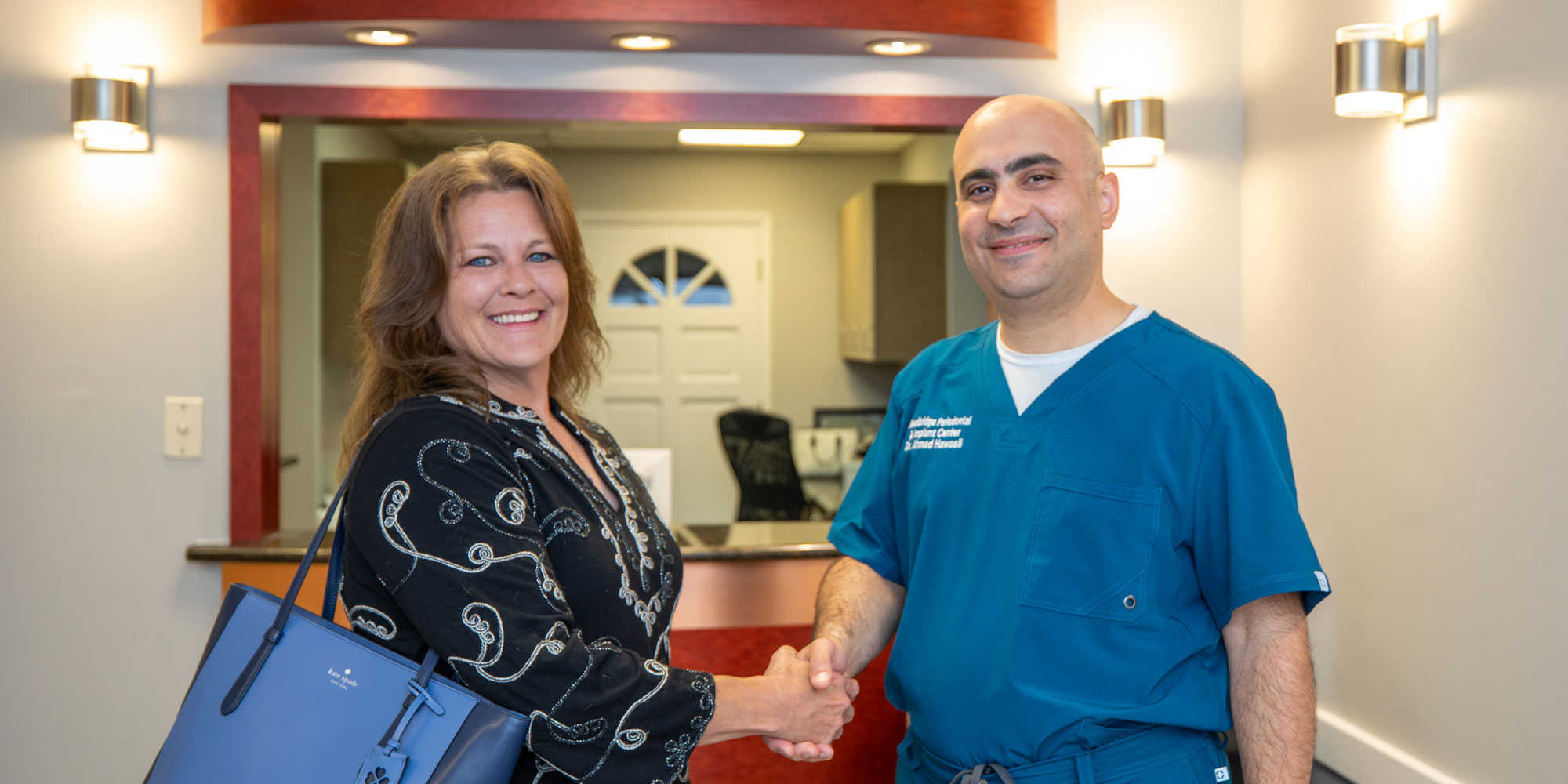dr with dental implant patient laura