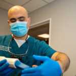 dr hawasli working on whitening a patients teeth that had become yellowed.